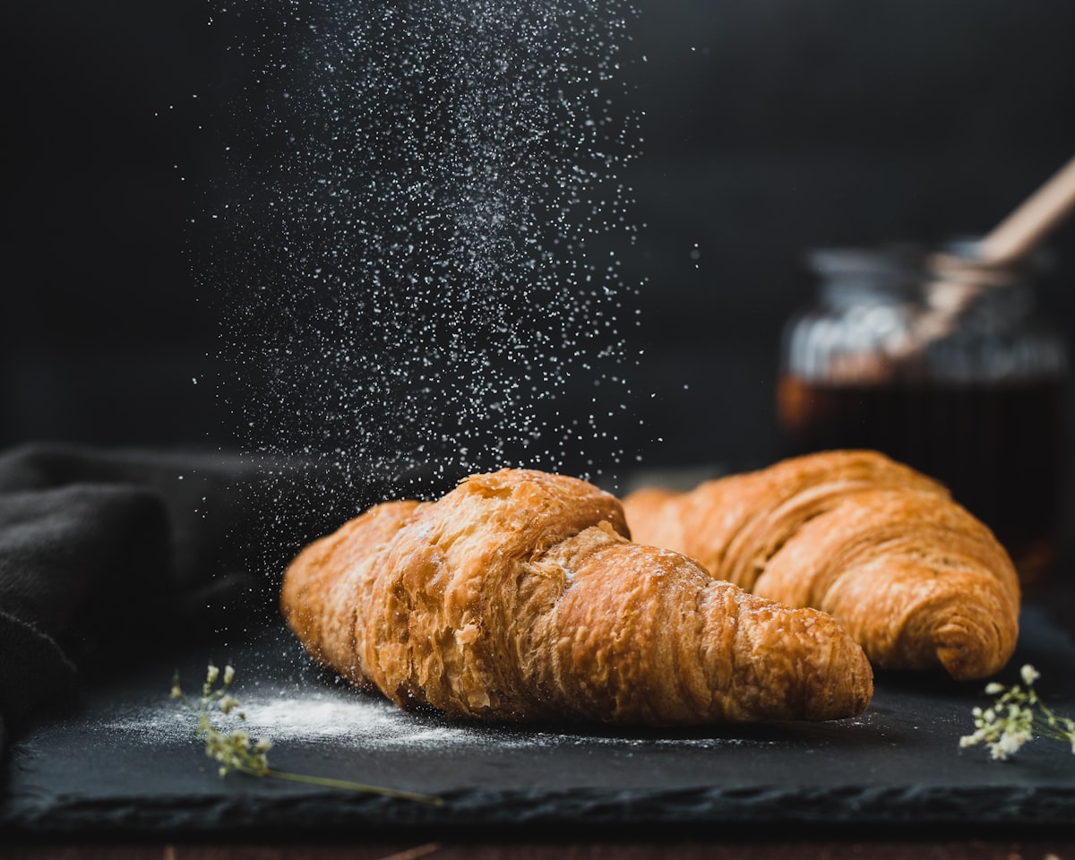 Fresh croissants dusted with icing sugar