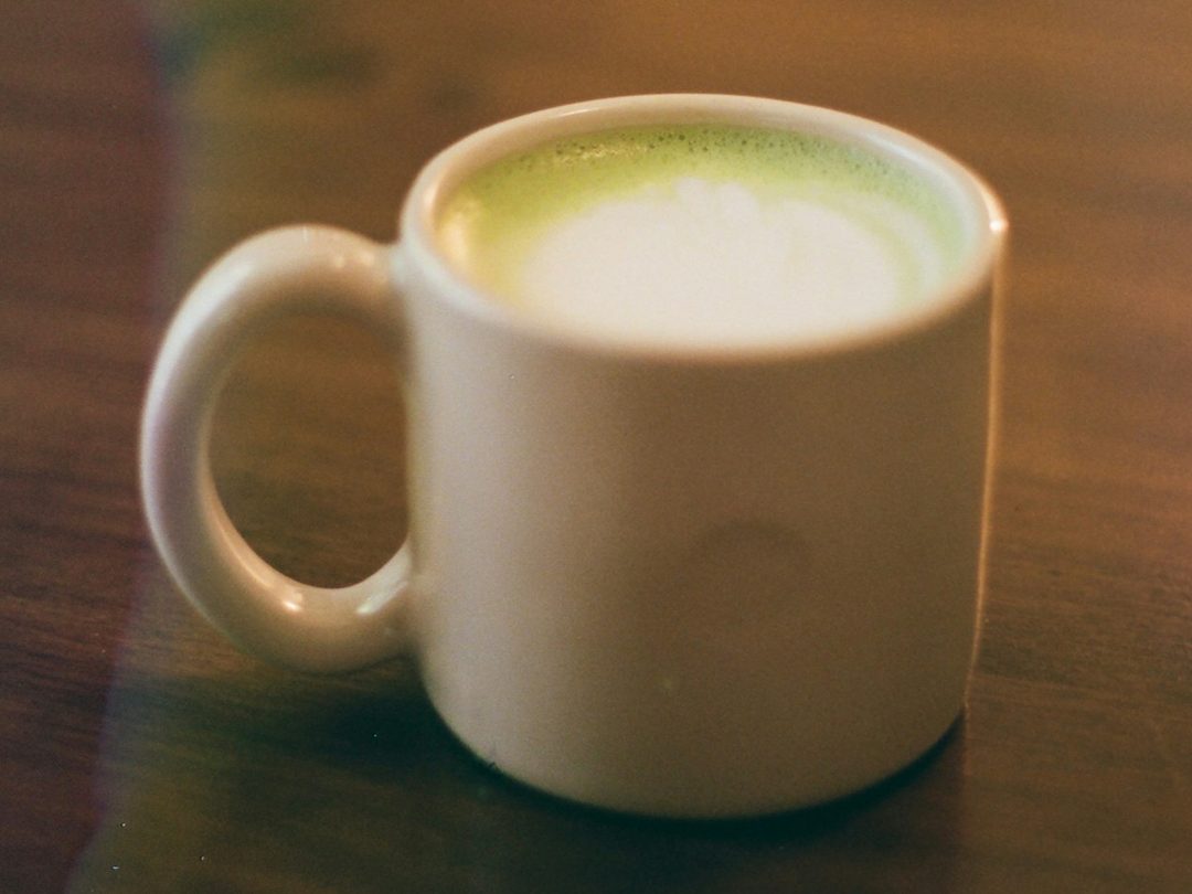 A matcha latte in a white mug